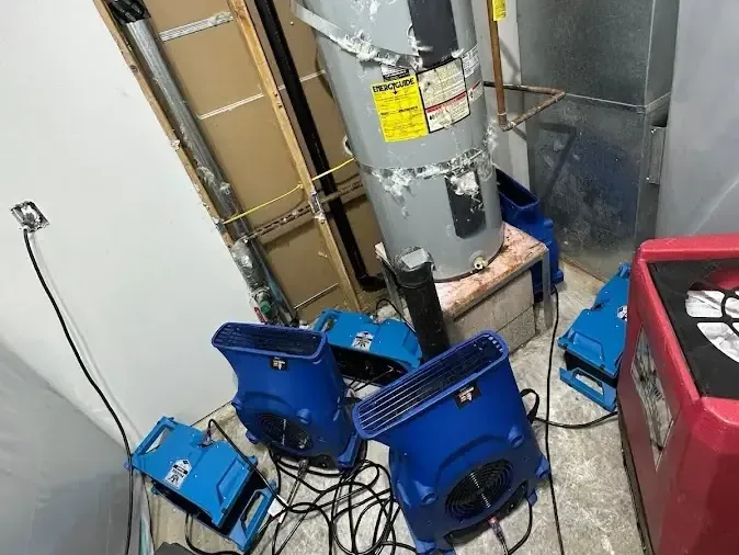 Drying units surrounding a water heater in a utility space